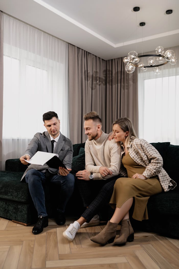 A realtor presenting property options to a couple in a modern living room setting.